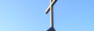Photograph of cross on roof of church